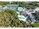 Community aerial view showcasing tennis courts, swimming pool, and lush landscaping at 10144 Arbor Run Dr # 139, Tampa, FL 33647