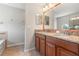 Bathroom featuring granite countertops, double sinks, and a large mirror for a luxurious feel at 10144 Arbor Run Dr # 139, Tampa, FL 33647