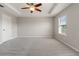 Spacious bedroom with neutral carpet, paint, ceiling fan, and a window providing natural light at 10144 Arbor Run Dr # 139, Tampa, FL 33647