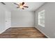 Bright bedroom featuring modern ceiling fan, wood-look floors and a light-filled window at 10144 Arbor Run Dr # 139, Tampa, FL 33647