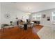 Bright dining area with hardwood floors and a modern chandelier at 10144 Arbor Run Dr # 139, Tampa, FL 33647