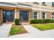 Inviting townhome featuring a well-maintained lawn and a covered front entrance with decorative details at 10144 Arbor Run Dr # 139, Tampa, FL 33647