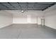 Spacious two car garage featuring epoxy flooring, water heater and high ceilings at 10144 Arbor Run Dr # 139, Tampa, FL 33647