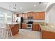 Bright kitchen with wood cabinets, stainless steel appliances, and a cozy island with seating at 10144 Arbor Run Dr # 139, Tampa, FL 33647