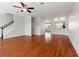 Bright living room featuring hardwood floors, neutral walls, and a staircase leading upstairs at 10144 Arbor Run Dr # 139, Tampa, FL 33647