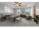 Stylish main bedroom features neutral tones, tray ceiling with fan and seating area bathed in natural light at 10144 Arbor Run Dr # 139, Tampa, FL 33647