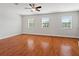 Spacious bedroom with hardwood floors, neutral walls, and three large windows at 10144 Arbor Run Dr # 139, Tampa, FL 33647