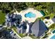 Aerial view of a community pool with seating and lush landscaping at 10144 Arbor Run Dr # 139, Tampa, FL 33647