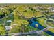Aerial view of a lush golf course community with mature trees, serene ponds, and well-maintained fairways at 10213 Lockwood Pines Ln, Tampa, FL 33635