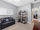 Cozy bedroom features a sleeper sofa, shelving, and neutral decor for a comfortable space at 10213 Lockwood Pines Ln, Tampa, FL 33635
