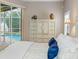 Bright bedroom featuring dresser, stylish decor and a backyard view at 10213 Lockwood Pines Ln, Tampa, FL 33635