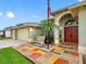 Beautiful home entrance with colorful tiled landing, arched entrance, and an American flag waving above at 10213 Lockwood Pines Ln, Tampa, FL 33635