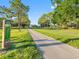 Scenic view of a golf course fairway with a clear path, manicured greens, and mature trees under a blue sky at 10213 Lockwood Pines Ln, Tampa, FL 33635