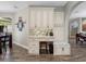 Hall tree with bench and hooks between kitchen and dining area at 10213 Lockwood Pines Ln, Tampa, FL 33635