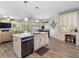 Open-concept kitchen with center island and modern appliances connected to the living room at 10213 Lockwood Pines Ln, Tampa, FL 33635
