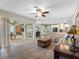 Bright living room featuring a seamless flow to outdoor screened patio and open-concept kitchen at 10213 Lockwood Pines Ln, Tampa, FL 33635