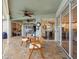 Covered patio with brick flooring, comfortable seating, sliding glass doors to the interior, and ceiling fans at 10213 Lockwood Pines Ln, Tampa, FL 33635