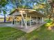 Covered picnic area with tables and benches near a playground for outdoor dining and Gathering fun at 10213 Lockwood Pines Ln, Tampa, FL 33635