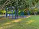 Outdoor workout area featuring bars and various exercise equipment surrounded by lush greenery and mature trees at 10213 Lockwood Pines Ln, Tampa, FL 33635