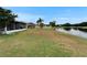 Expansive backyard featuring a screened-in lanai and serene views of the adjacent pond at 1040 Summer Breeze Dr, Brandon, FL 33511