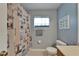 Nautical-themed bathroom featuring a shower with decorative curtain, and neutral colored tile floor at 1040 Summer Breeze Dr, Brandon, FL 33511