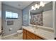 Bathroom featuring a mirror with lights and decorative maritime-themed shower curtain, towel, and picture at 1040 Summer Breeze Dr, Brandon, FL 33511