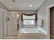 Bright bathroom with a soaking tub, separate shower, and large window at 1040 Summer Breeze Dr, Brandon, FL 33511
