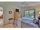 Bedroom with a ceiling fan, wood floors, and views of the lake at 1040 Summer Breeze Dr, Brandon, FL 33511