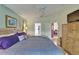 Charming bedroom with wood floors, a ceiling fan, and access to the bathroom at 1040 Summer Breeze Dr, Brandon, FL 33511