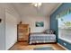 Cozy bedroom features wood-look floors, a colorful quilt, and a full closet for ample storage at 1040 Summer Breeze Dr, Brandon, FL 33511