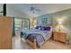Bright bedroom featuring wood floors, a ceiling fan, and views of the lake at 1040 Summer Breeze Dr, Brandon, FL 33511