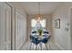 Cozy breakfast nook with a round table, charming chandelier and plenty of natural light from the window at 1040 Summer Breeze Dr, Brandon, FL 33511