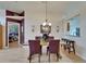 Dining room boasts wood floors, a chandelier, and views into the bedroom and kitchen at 1040 Summer Breeze Dr, Brandon, FL 33511