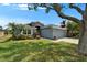 Inviting single-story home with a manicured lawn, mature landscaping, and a two-car garage, offering curb appeal and charm at 1040 Summer Breeze Dr, Brandon, FL 33511