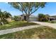 Charming single-story home featuring a manicured lawn, mature trees, and a welcoming entrance at 1040 Summer Breeze Dr, Brandon, FL 33511