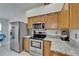 Kitchen showcases stainless steel appliances, granite countertops, and wooden cabinetry, blending style with functionality at 1040 Summer Breeze Dr, Brandon, FL 33511
