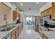 Bright kitchen features stainless steel appliances, granite countertops, and wooden cabinets, leading to a breakfast nook at 1040 Summer Breeze Dr, Brandon, FL 33511