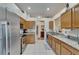 Functional kitchen featuring stainless steel appliances, granite countertops, and wooden cabinetry, providing ample workspace at 1040 Summer Breeze Dr, Brandon, FL 33511