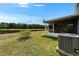 Backyard view with a screened lanai, lush greenery, and the tranquil pond beyond at 1040 Summer Breeze Dr, Brandon, FL 33511