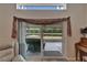 Open living room featuring sliding glass doors leading to lanai with stunning view of the pond at 1040 Summer Breeze Dr, Brandon, FL 33511