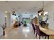 Open-concept living area boasts wood floors, a ceiling fan, and sliding door access to the lanai at 1040 Summer Breeze Dr, Brandon, FL 33511