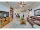 Spacious living room with wood floors, a ceiling fan, and open floor plan to the dining area at 1040 Summer Breeze Dr, Brandon, FL 33511