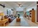 Open living room featuring a comfortable leather sofa, entertainment center, and access to lanai at 1040 Summer Breeze Dr, Brandon, FL 33511