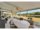 Large outdoor patio with a beautiful backyard lake view, tables, plants, and fans at 1040 Summer Breeze Dr, Brandon, FL 33511