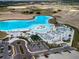 Overhead perspective of a Primary-planned community featuring a lagoon, sandy beach, water activities, and leisure areas at 10446 Tupper Cay Dr, San Antonio, FL 33576