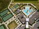 Aerial view of community amenities: tennis, shuffleboard, and large resort-style pool with ample seating at 10446 Tupper Cay Dr, San Antonio, FL 33576