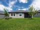 Backyard with a screened in patio and green grass at 10446 Tupper Cay Dr, San Antonio, FL 33576