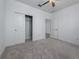 Bedroom with sliding closet doors and carpet flooring at 10446 Tupper Cay Dr, San Antonio, FL 33576