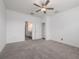 Bright bedroom with a ceiling fan and neutral carpet and paint at 10446 Tupper Cay Dr, San Antonio, FL 33576