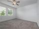 Spacious bedroom with neutral carpet, two windows, and ample natural light at 10446 Tupper Cay Dr, San Antonio, FL 33576